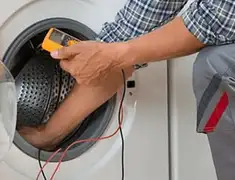 Washing machine repair technician testing a front-load washer with diagnostic tools in Allentown, PA